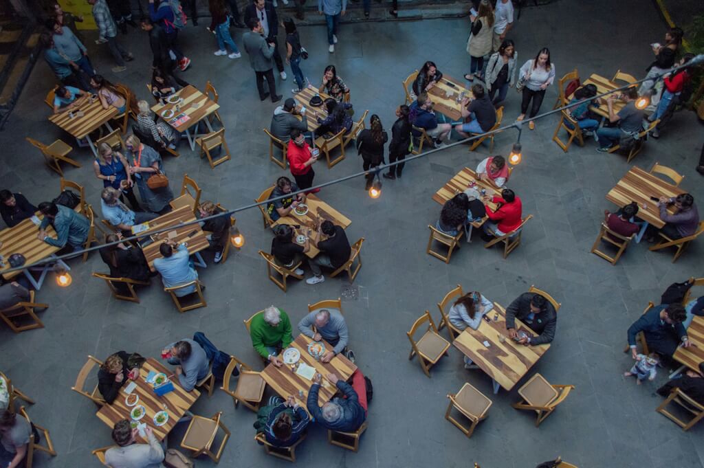 Over top view of outdoor restaurant seating and people